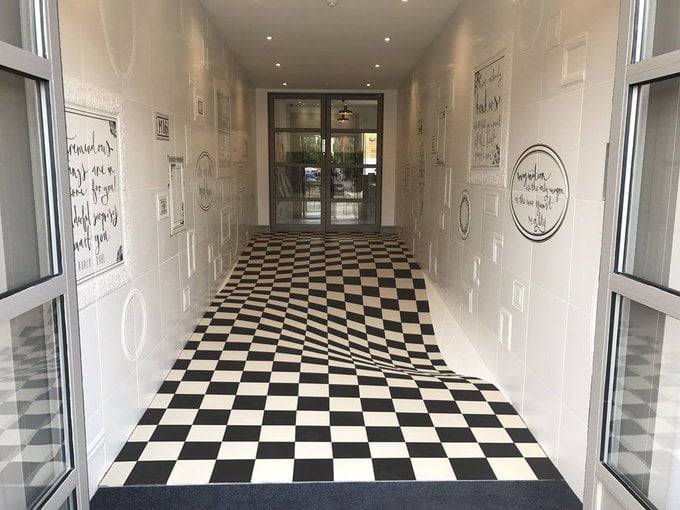 An optical illusion designed by Casa Ceramic to stop people running down the hallway. The floor is actually flat.