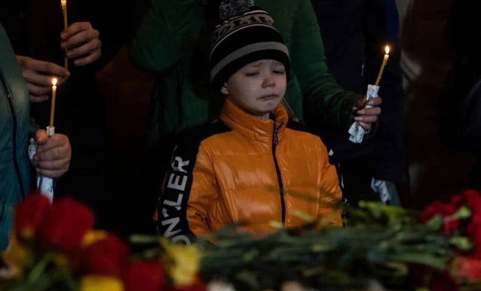 A boy cries during a memorial service for his 11-year-old sister Sofia and 17-year-old brother Kirill. Children were killed by a Russian rocket that hit a nine-story building in Uman on April 28....
