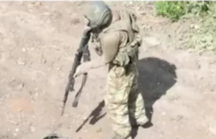 Russian soldier helping his wounded comrade.