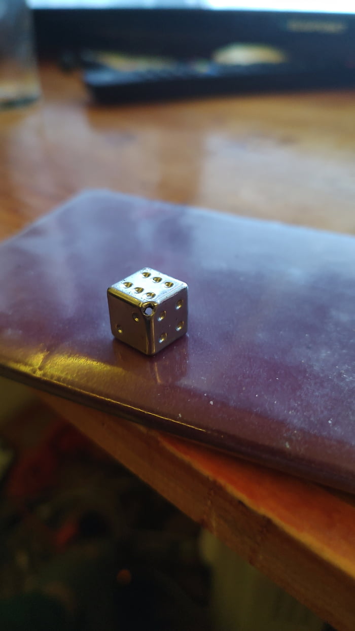 This old monopoly dice has holes in 2 corners to counter choking hazards