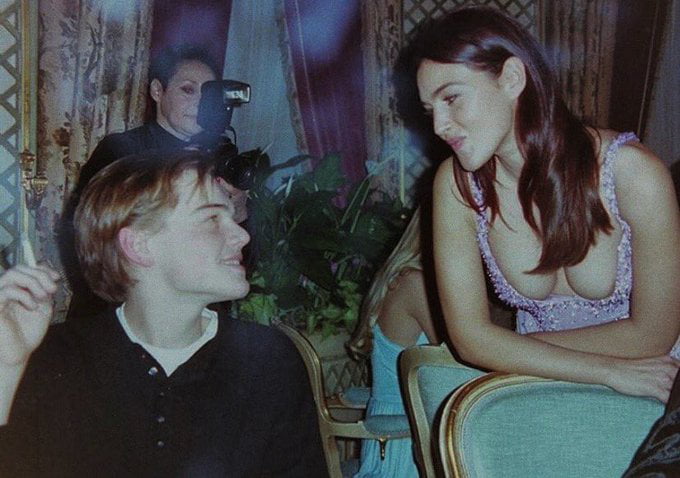 Leonardo DiCaprio and Monica Bellucci at Versace's dinner during Paris Couture Week, 1995