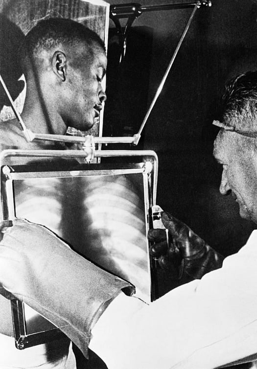 1954. A black worker in a South African diamond mine behind an X-ray machine. They were scanned at the end of each shift to prevent them from swallowing diamonds and smuggling them out.