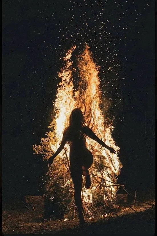 Girl dances around the campfire