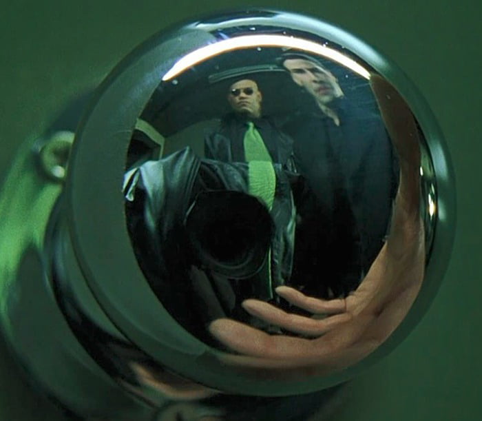 The Matrix: Mirrored doorknob: There was no way to properly hide the camera, so the director of photography threw a coat onto himself with a tie matching the one Morpheus was wearing, trying to blend in as much as possible.